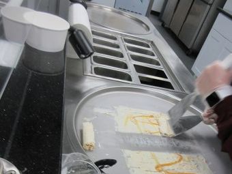 Person making ice cream on a cold plate.