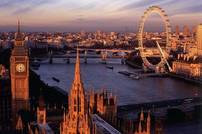 Sunset over the Palace of Westminster and the London Eye in London.