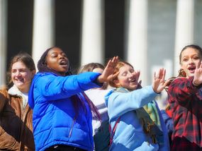 A group of teenage girls pose for a photo.