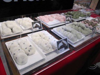 A variety of Japanese mochi desserts on display.