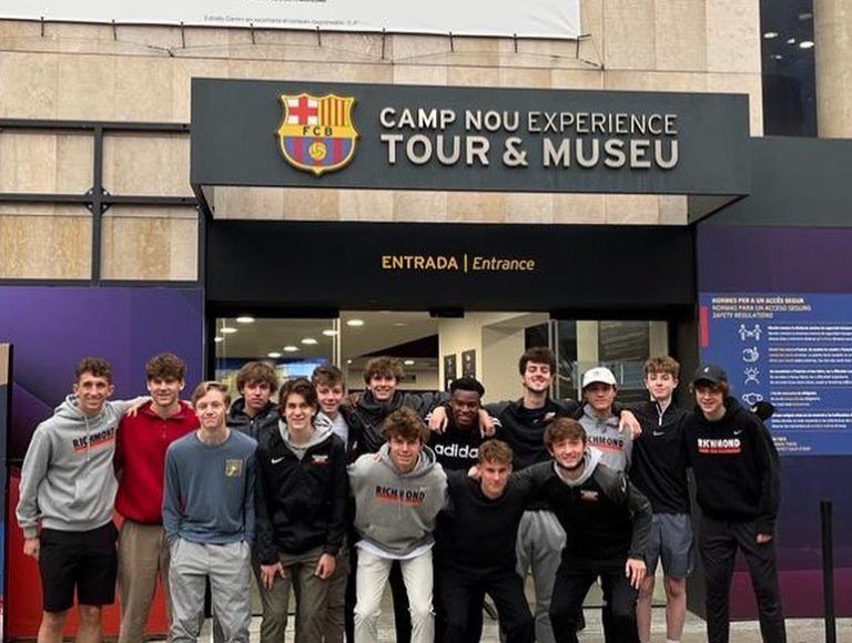 A group of young adults at the entrance to the Camp Nou Experience Tour & Museu.