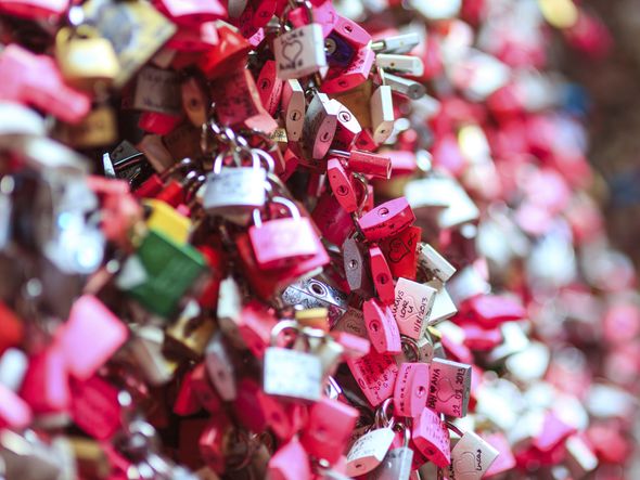 Close-up of colorful love locks on a bridge.