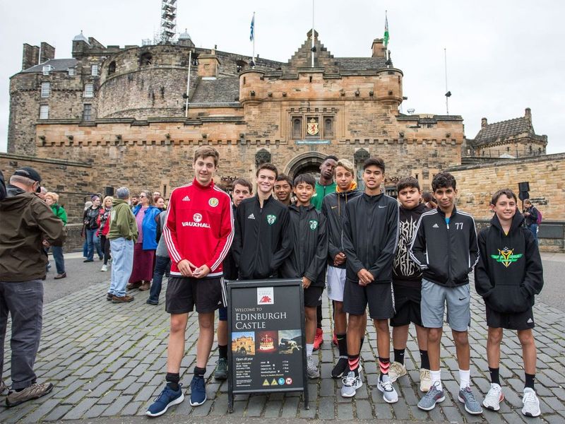 Group of teenage boys posing in front of Edinburgh Castle