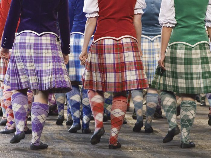 Highland dancers perform in colorful kilts, showcasing traditional Scottish dance.