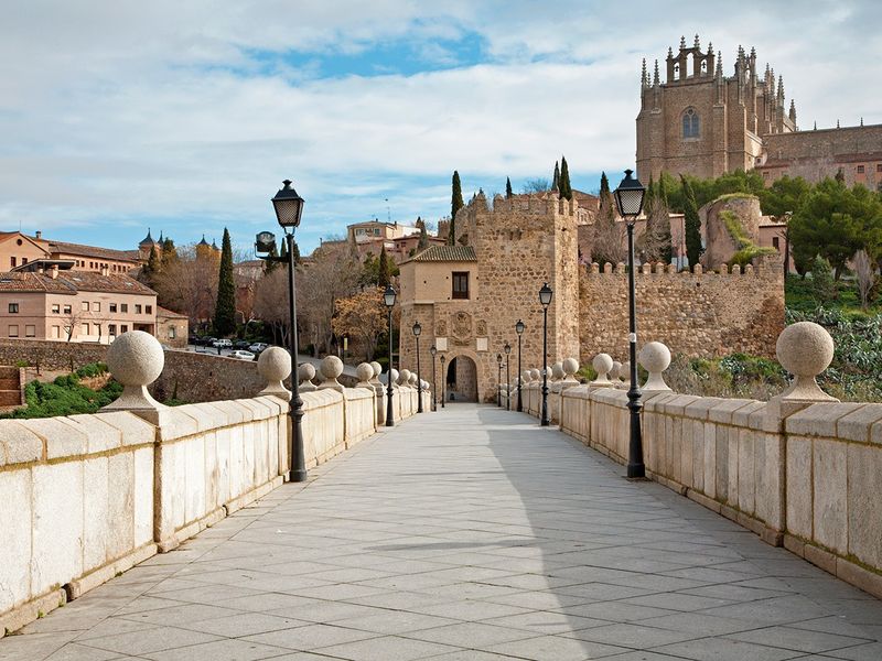 View of the Alcántara Bridge and San Servando Castle in Toledo, Spain