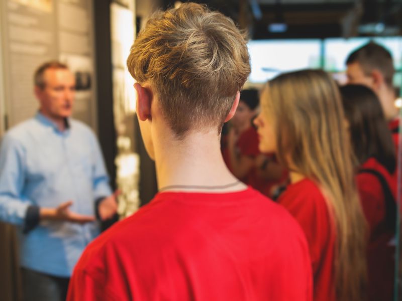 Students listening to a docent in a museum