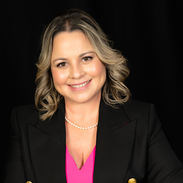 Smiling Woman in Black Blazer and Pink Top