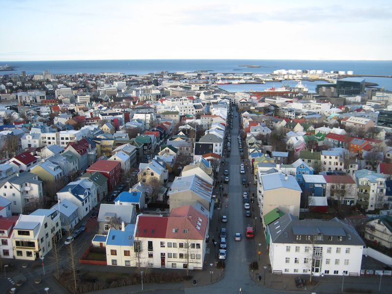 High-angle view of Reykjavik, Iceland, with colorful buildings and a street leading to the sea.