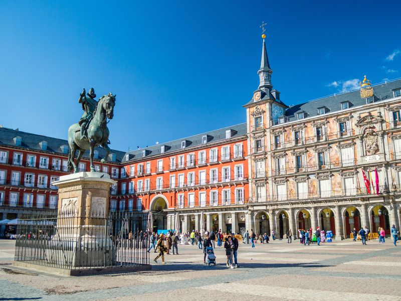 A view of Madrid's Plaza Mayor with the statue of King Philip III in the foreground.