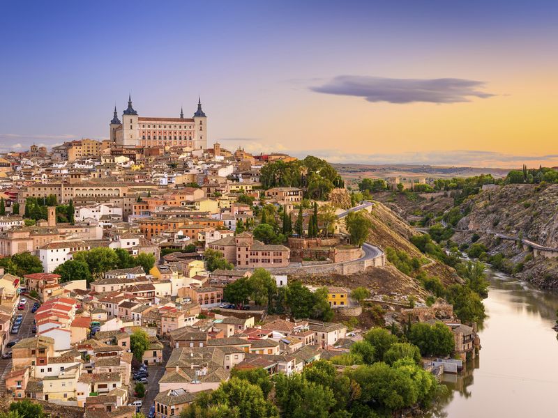 Sunset over Toledo, Spain. The Alcazar of Toledo is high on a hill overlooking the city and the Tagus River. 