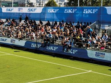 Youth soccer game at the Gothia Cup with international flags in the background.