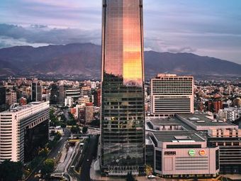 A modern skyscraper in Santiago, Chile, at sunset.