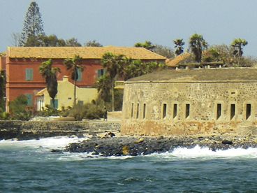 Historic island fort off the coast with waves crashing around it.