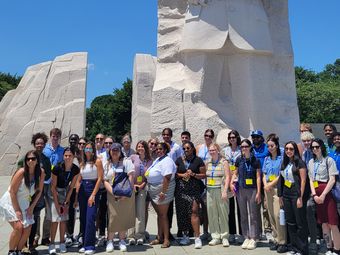 Group of young adults posing in front of the Martin Luther King Jr. Memorial in Washington, D.C.