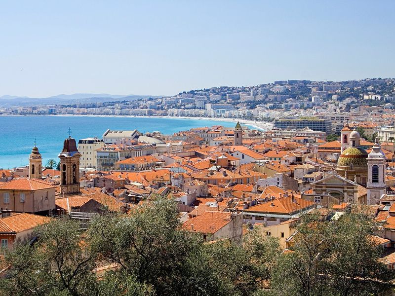 Scenic view of Nice, France, with its characteristic orange rooftops and the Mediterranean Sea in the background.