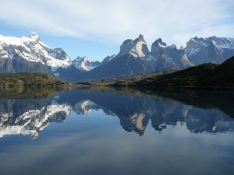 Majestic mountains reflected in a tranquil lake in Torres del Paine National Park.