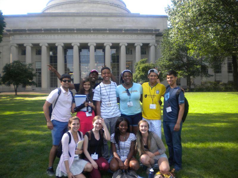 A group of students pose in front of the MIT dome.